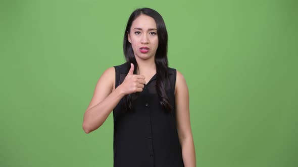 Young Upset Asian Businesswoman Giving Thumbs Up