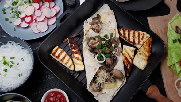 Assortment of Street Food on a Dark Wood Table