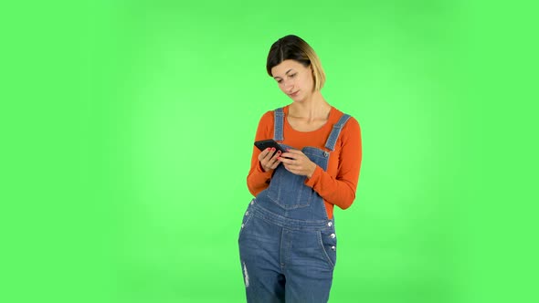 Woman Texting on Her Phone. Green Screen