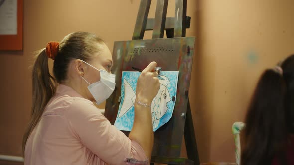 Woman Artist Learns to Paint with Airbrush with Acrylic Dye Paper and Easel