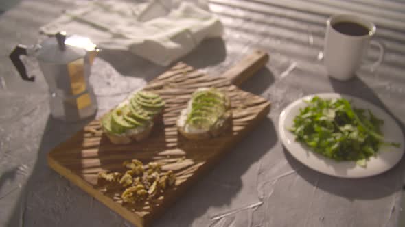 Healthy Breakfast Concept. Toast with Avocado Cream on Wooden Board