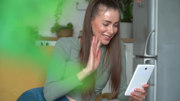 Portrait of Woman Talks Video Calling on Tablet at Home Laughs and Greets Friend