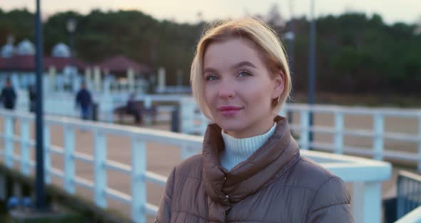 Portrait of a Young Blonde with Short Hair on a Sunset Background