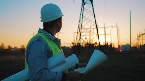 Architect Worker Checking Construction Project On Electric Tower