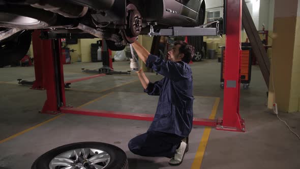 Auto Repair Specialist During Car Chassis Check