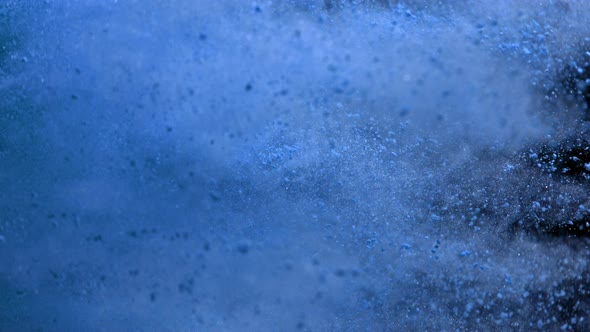 Super Slowmotion Shot of Side Blue Powder Explosion Isolated on Black Background at 1000Fps