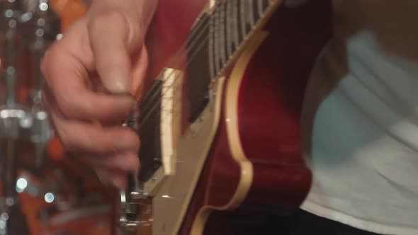 Guitarist Plays the Guitar As Part of a Band at a Concert