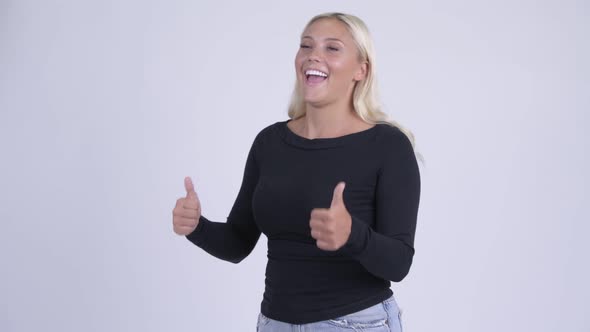 Young Happy Blonde Woman Looking Excited While Giving Thumbs Up