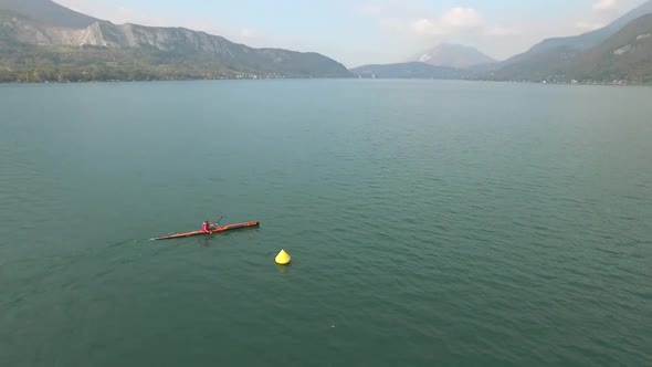 A kayaker paddles in a scenic mountain lake.