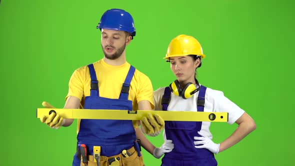 Brigadier Holds a Building Level in His Hands and Measures the Surface. Green Screen