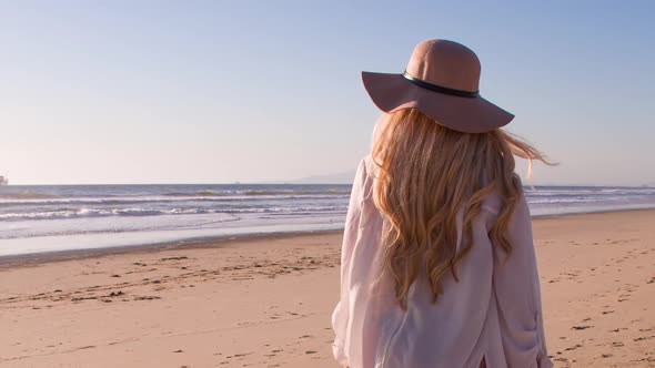 Attractive Blond Woman Walking on the Beach