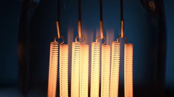 Electric Vintage Edison Light Bulb with a Spiral Flashing on a Blue Background