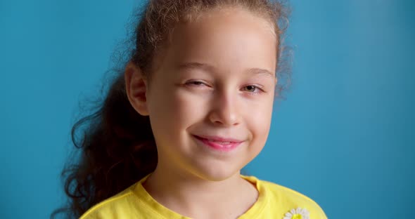 Portrait Funny Little Girl Smiling Child Looking at Camera are Sitting on the Blue Background Cute