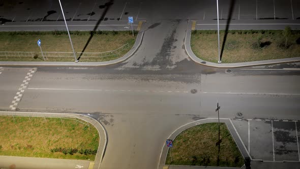 Night Timelapse at a Crossroads Along Which Cars are Moving Fast with a Dynamic Zoom Effect and Blur