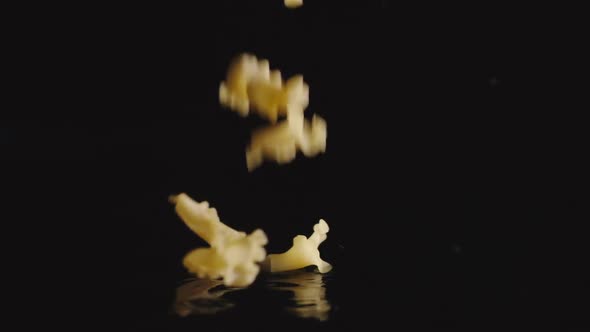 Figural pasta falls into water - Slow Motion