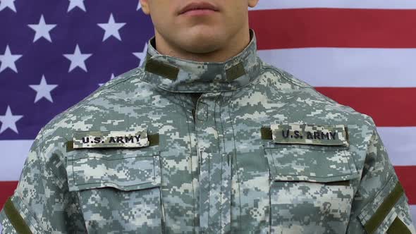 Patriotic Soldier Holding Hand on Heart, US National Flag Background, Defense