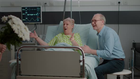 Family Surprising Retired Patient with Flowers and Visit