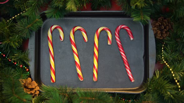 Striped Candy Canes Moving on Baking Tray Forming Heart, Happy Celebration