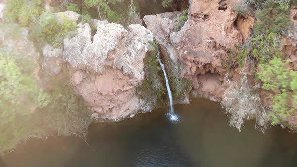 Pego do Inferno,  small waterfall in Santo Estevao, Tavira, Algarve. Aerial dolly out 