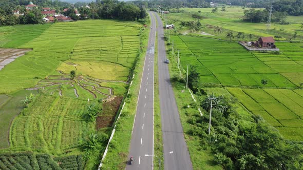 Drone footage to aerial highway beside farmland