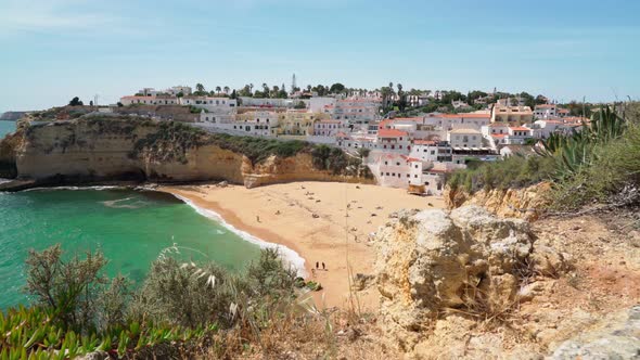 Beautiful View of the Portuguese Carvoeiro Beach in Summer with Clear Sea and Sunbathing Tourists