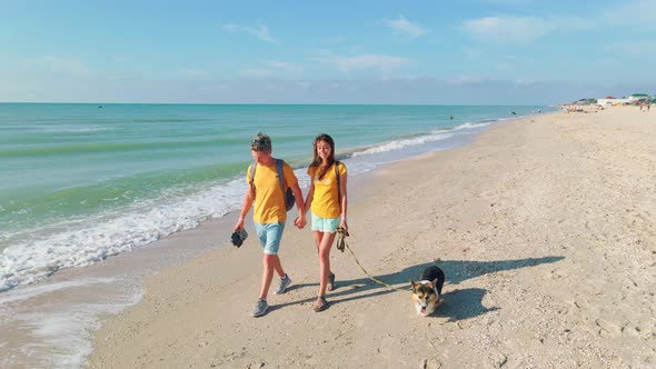 Happy Couple with Dog Walking Sea Beach