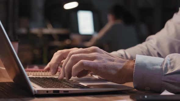 Male Hands Typing On Laptop At Night