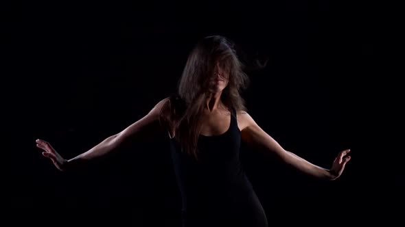 Dancing Woman in Black Background, Performing Passionate Modern Dance, Waving Hands
