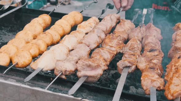 Shish Kebab and Mushrooms on Skewers Cooked on Barbecue at Street Food Festival