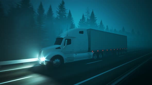 Semi truck with trailer driving through the forest during foggy night. Loop 4K