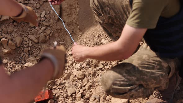 Explosives Expert a Saboteur Wearing Camouflage a Balaclava Helmet and a Miner Explosive Device