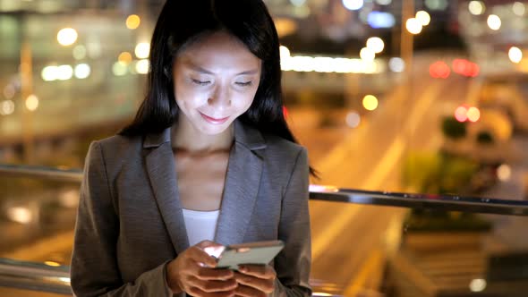 Young woman using mobile phone in city 