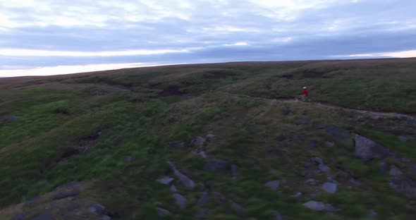 Aerial shot of a mountain biker on a singletrack trail.