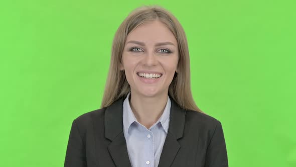 Cheerful Businesswoman Smiling at Camera Against Chroma Key