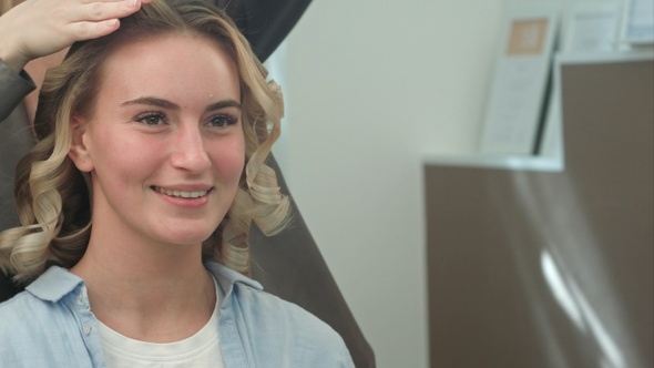 A woman in a hairdressing salon waiting to see the results