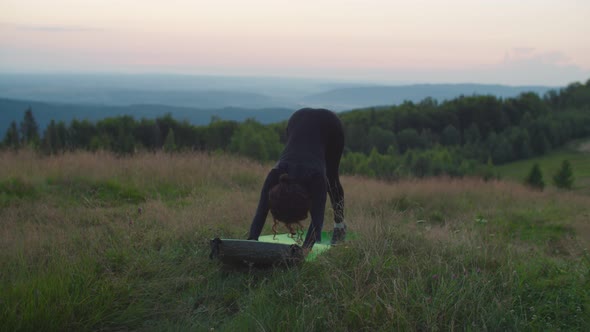 Slim Flexible Sporty Fit African American Female Doing Downward Facing Dog Pose in Mountains at
