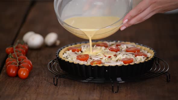 Step By Step Woman Making Quiche Lorraine with Chicken, Mushrooms and cheese.French Cuisine.