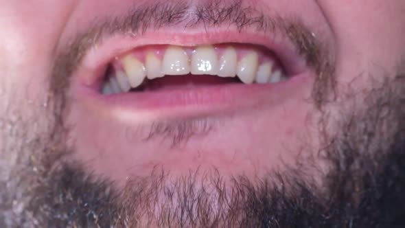 The Mouth of a Man Who Aggressively Shouts Into the Camera