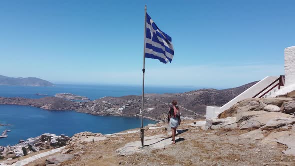 Aerial view of top of Ios island, Greece. Woman walks to the church