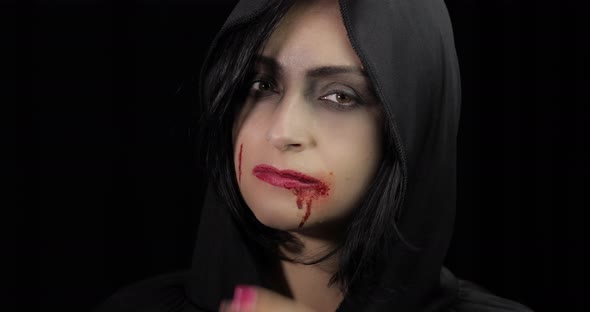 Vampire Halloween Makeup. Woman Portrait with Blood on Her Face.