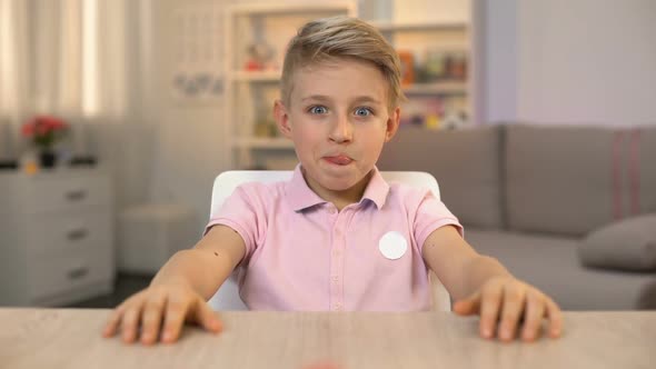 Excited Little Boy Looking Delicious Cream Cake on Kitchen Table, Sugar Dessert