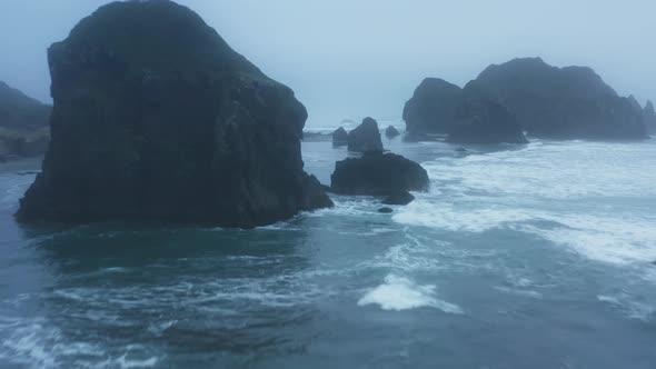 Aerial Footage of the Stormy Sea with Foamy Waves Breaking Against the Rocks