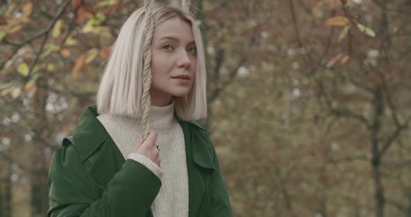 Thoughtful Woman Swinging in Solitude Under a Big Tree in Autumn. Slow Motion