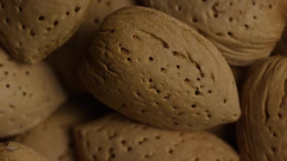 Cinematic, rotating shot of almonds on a white surface - ALMONDS