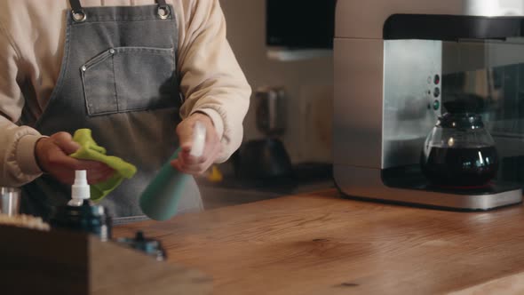 Young Asian Man Waiter Barman or Worker in Cafe Restaurant Cleaning Bar Counter with Duster While