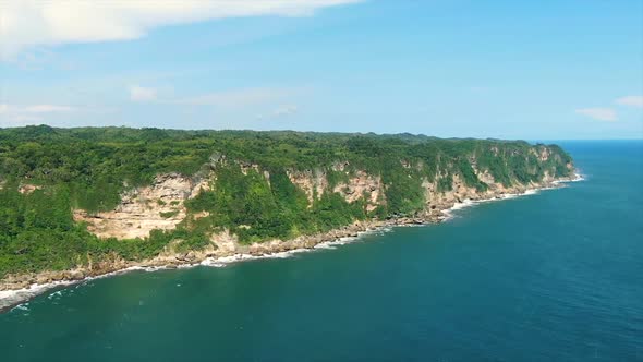 Majestic coastline cliffs in Indonesia, Parangtritis beach, aerial drone view