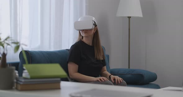 Technology of Virtual Reality Today Woman with HMDdisplay on Head in Apartment Looking Around