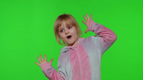 Child Girl in Unicorn Pajamas Making Silly Funny Faces Fooling Around Showing Tongue on Chroma Key