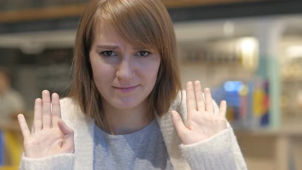 Young Woman Disliking and Rejecting Offer in Cafe