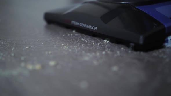 Vertical Cleaner Vacuuming Closeup Cleaning the Floor at Home